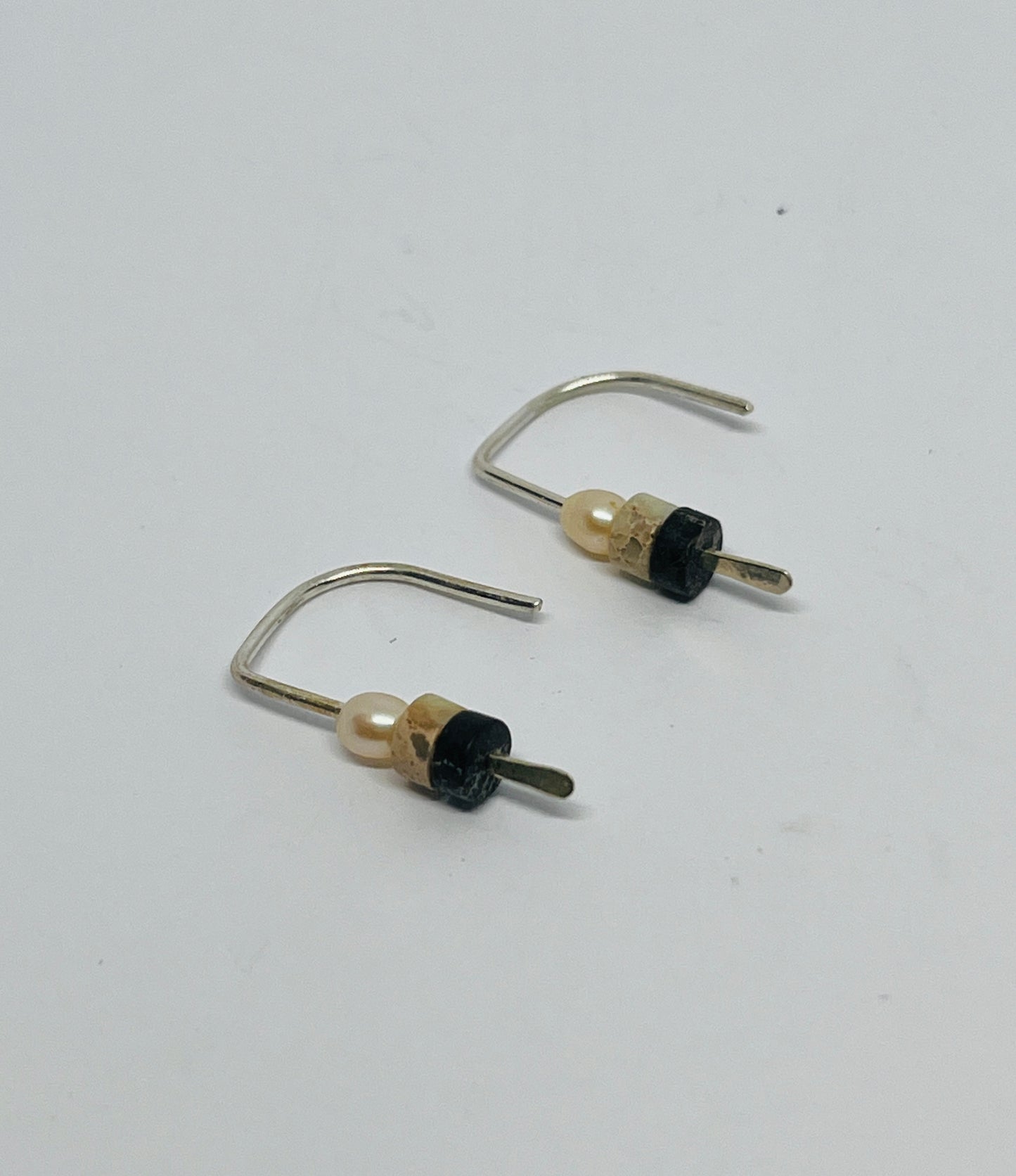 stunning combination of pearl quartz and obsidian, each stone telling a timeless story of journeys through history.