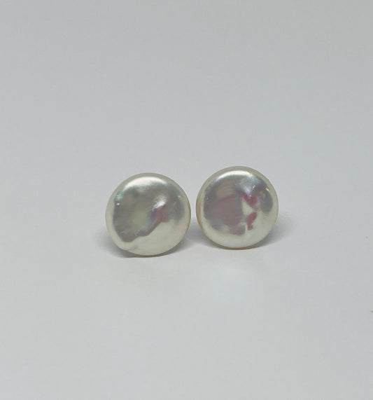 Pair of Baroque pearl stud earrings on a light gray background