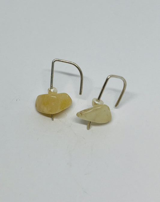 a luxurious pearl suspended alongside a striking ember natural stone, elegantly dangling from sterling silver posts. Each element in this design embodies the essence of empowerment and the enduring spirit within every woman.