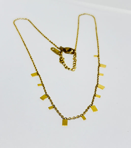 Gold necklace with rectangular pendants on a white background