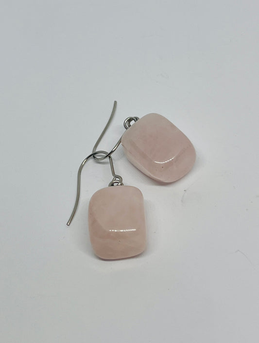 earrings feature rectangles of rose quartz — smooth, pale pink, and quietly luminous. Suspended from polished stainless steel hooks, they move with ease and grace, catching light with a subtle glow.