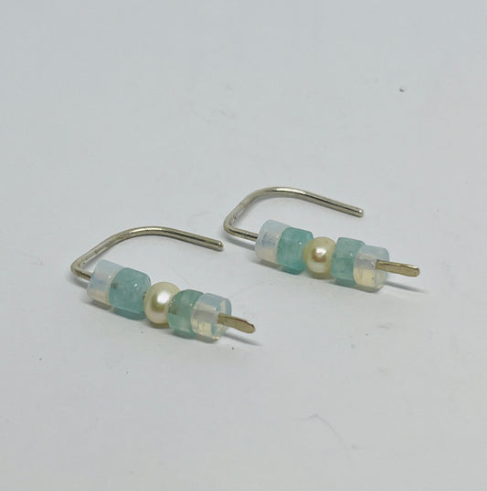 handcrafted earrings are a quiet homage to the elements — combining the gentle glow of moonstone, the clear calm of aquamarine, and the timeless grace of freshwater pearl. Suspended from sterling silver in a unique dangle form, each element moves with you, like ripples on water or moonlight on skin.